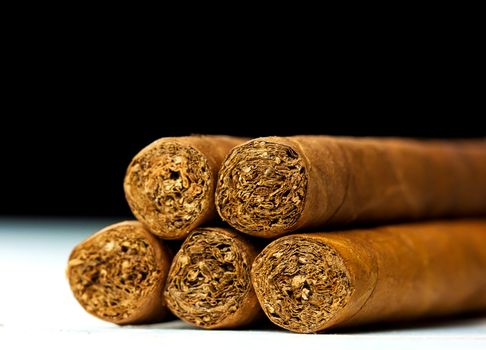 Close up picture of five cigars in the studio