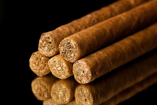 Close up picture of five cigars in the studio