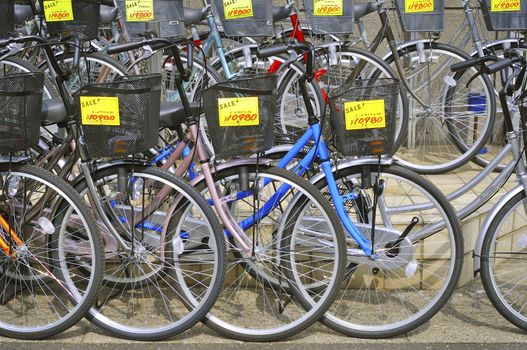 TOKYO, JAPAN -APRIL 22, 2011 : row of new bicycles with sale prices on Tokyo street