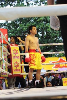 SURAT THANI, THAILAND - DECEMBER 14 : Decha Kokietgym wait to fight boxig with Chenyujie on December 14, 2012 in Surat Thani, Thailand.