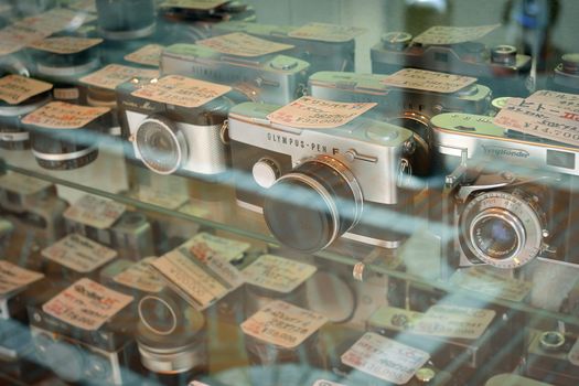TOKYO, JAPAN -APRIL 22, 2011 : used film cameras store window with many vintage items 
