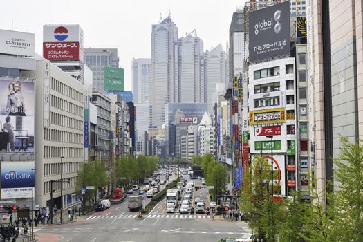 Tokyo, Japan -April 22, 2011 : general view to the city street in Famous Shinjuku area of Tokyo Metropolis by daytime. Street direction is going toward Metropolis Government building number 2 (center of image). 