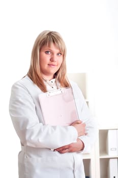 portrait of a young woman doctor with a clipboard, smiling