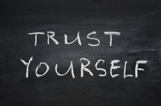 trust yourself phrase handwritten on school blackboard