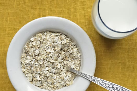 oat-flakes with milk closeup; focus on flakes