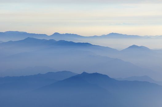 mountain ridges and skyline in soft pale haze morning atmosphere, Japan