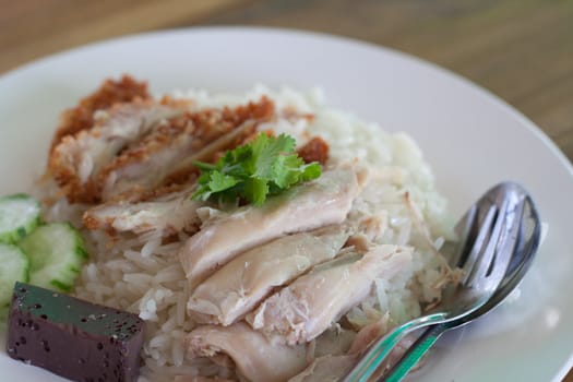 Rice with steamed chicken and fried chicken.