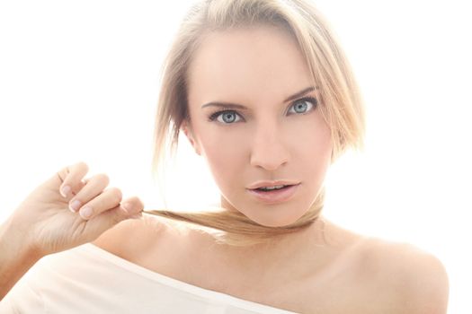 Portrait of beautiful and seductive woman looking at camera over a white background