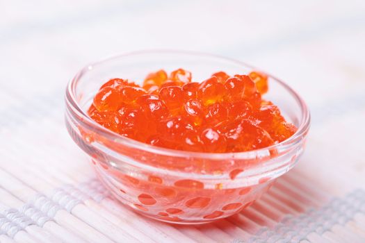 Close up of red tasty caviar in a jar