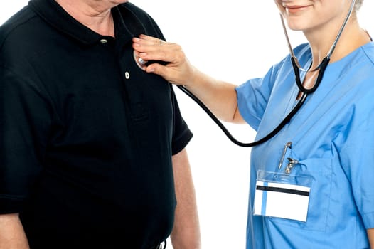 Cropped image of a smiling female doctor examining an aged male patient.