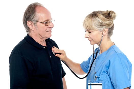 Female doctor examining an elderly man isolated against white background.