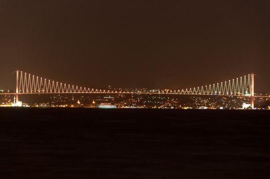 Illuminated Bosporus Bridge at night in Istanbul, Turkey
