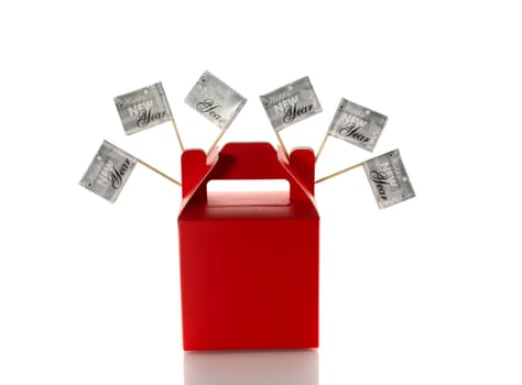 silver flags with happy new year on red gift box