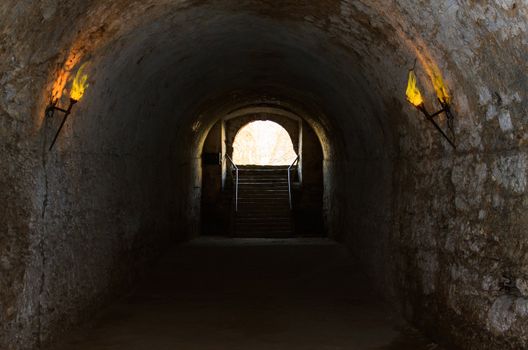 catacombs of the old castle illuminated burning torches