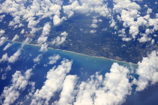 Indonesia, Bali. Coastline is visible through clouds. Aerial view