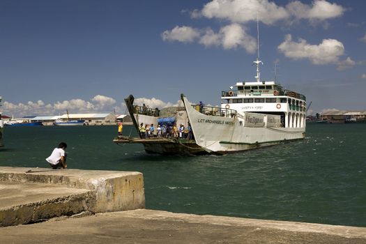 Feb. 2012 - Ferry Harbor, Bacolod City, Negros Oriental Island, Philippines - One of many inter island ferries transporting passengers and cargo among ports throughout the Philippine Islands. This ferry is a RORO, roll on roll off, called so because trucks, cars and buses can drive on and off of it. These ships are easy to capsize and sink if not loaded correctly.