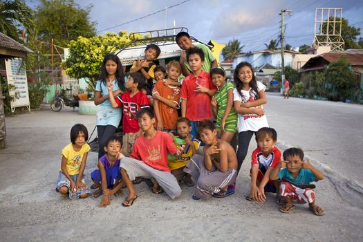 May 2012 - Bogo City, Cebu Island, Philippines - Portrait of a group of sixteen happy, smiling, healthy Filipino children. People in Bogo City are very friendly to foreigners and love to have their picture taken.