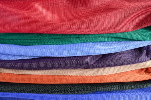 Pile of colorful folded clothes. Colorful clothes background.