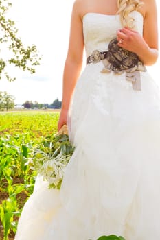 A beautiful bride holds her wedding bouquet before her ceremony with a stylish wedding photography abstract feel.