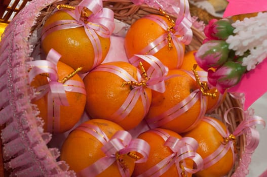 orange for gifts in basket with ribbon