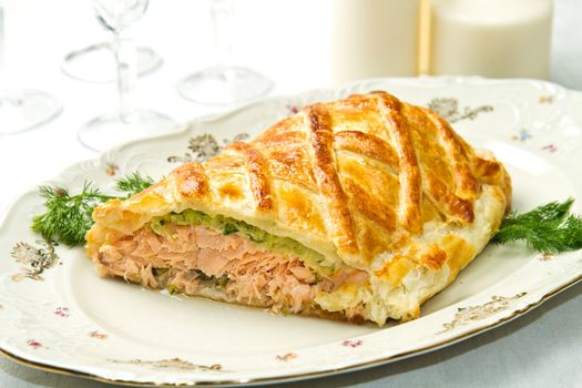 Traditional salmon in puff pastry with spinach and zucchini