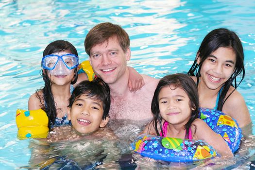 Family swimming in pool