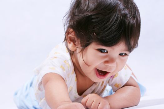 Happy smiling baby learning to crawl