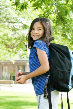 Eight year old biracial girl excited about first day of school.;