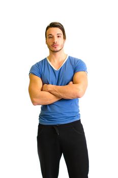 Handsome and athletic guy standing with arms crossed on his chest