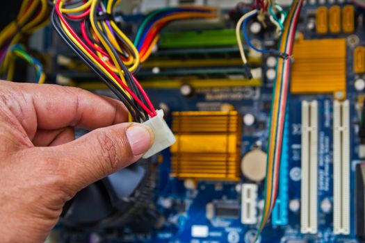 Technician repairing computer hardware in the lab