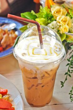 Cup of ice coffee on wooden table.