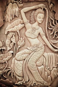 Carved woman on the wall. Thailand.