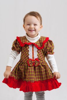 portrait of an happy smiling little blonde girl wearing a traditional dress