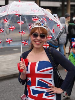 
LONDON - JUNE 3: A happy unidentified girl with Union Jack dress on the River Thames to witness Thames Diamond Jubilee Pageant on June 3, 2012 in London.