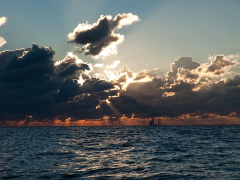 sunset with the boats on the sea just after the storm