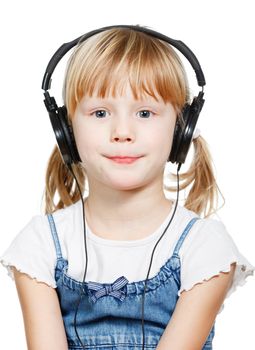 Portrait of cute 4 years girl wearing headphones over a white background