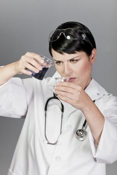 Scientific researcher or doctor looking at a liquid clear solution in a laboratory.