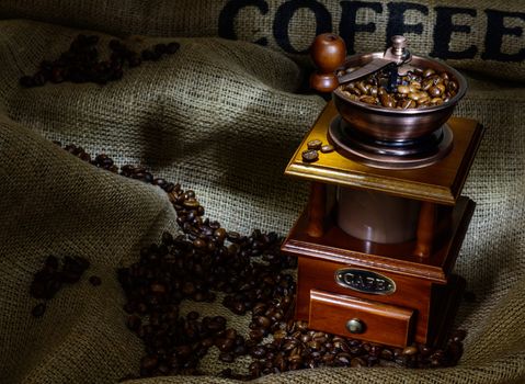 Coffee Mill with beans and burlap. still life