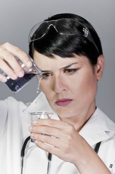 black substance being dropped from pipette into tube with water, laboratory tests