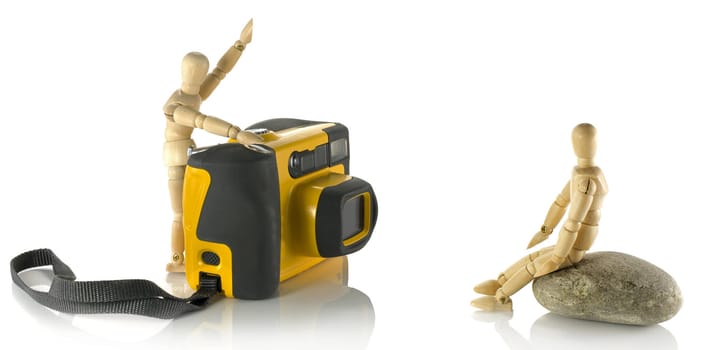 wooden puppet with yellow camera and model