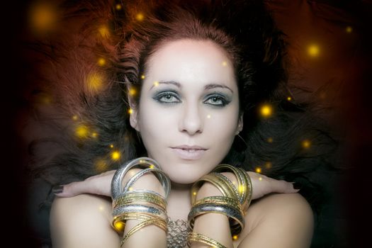 beautiful young woman portrait with long, mysterious lights floating around her