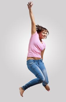 pretty modern slim hip-hop style woman jumping dancing on a colour background