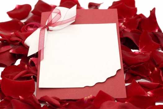 Greeting card on the background of petals of roses