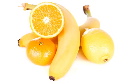 Lemon, banana, sliced orange and tangerine isolated on white background.
