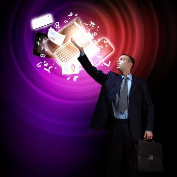 Businessman standing with modern technology symbols next to him