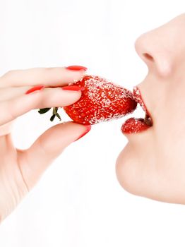 Young woman's mouth with red strawberry covered with sugar