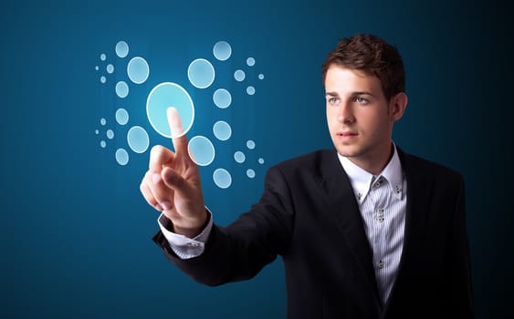 Businessman pressing high tech type of modern buttons on a virtual background