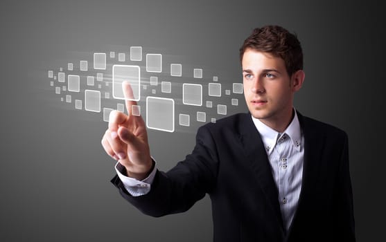 Businessman pressing high tech type of modern buttons on a virtual background
