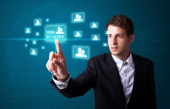 Businessman pressing modern social buttons on a virtual background