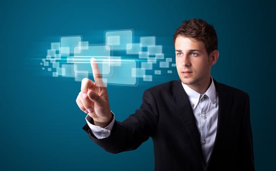 Businessman pressing high tech type of modern buttons on a virtual background